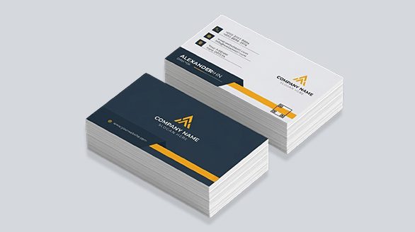 "An isometric view of two neat stacks of business cards showcasing a corporate design with a yellow triangular geometric logo, a charcoal grey front layout, and a structured white back layout with clean contact icons."