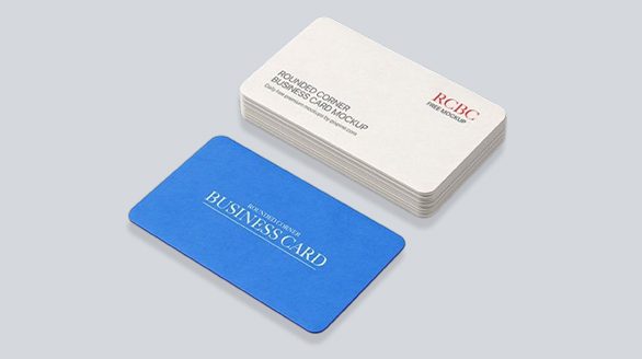 "An isometric view of a premium stack of white business cards with rounded corners next to a single solid blue rounded business card displaying elegant white typography on a clean grey background."