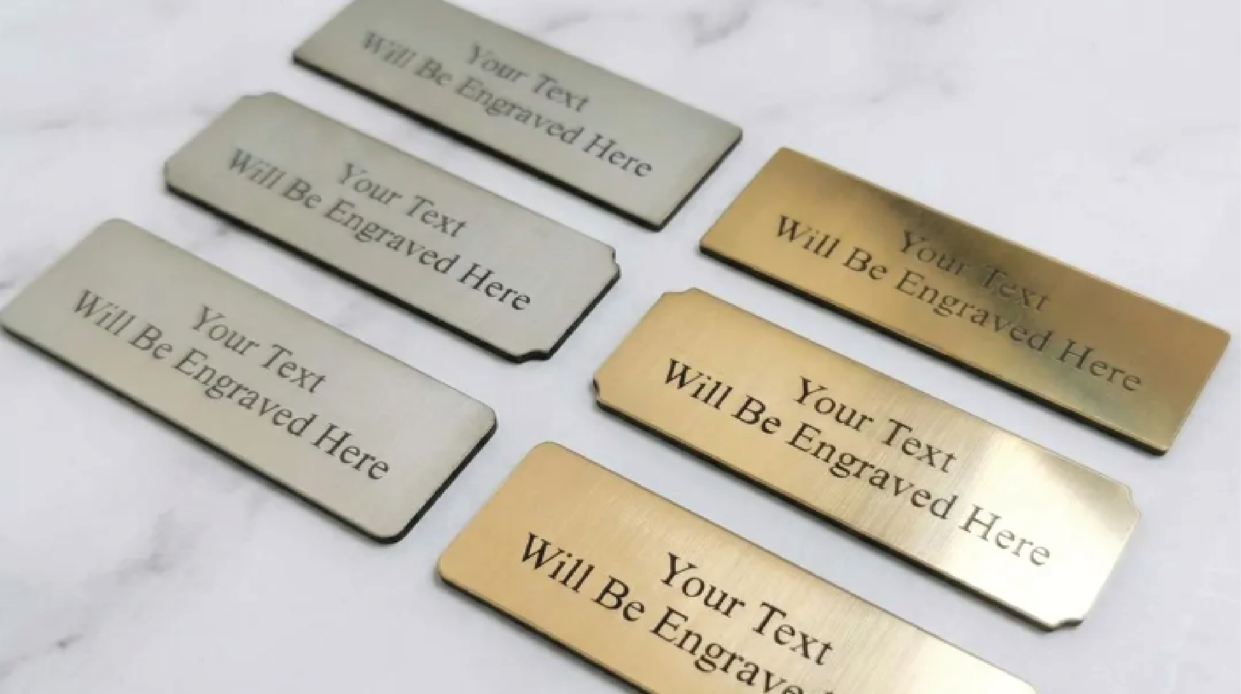 "Custom laser-engraved metal nameplates in brushed gold and silver finishes, perfect for office desks and door identification."
