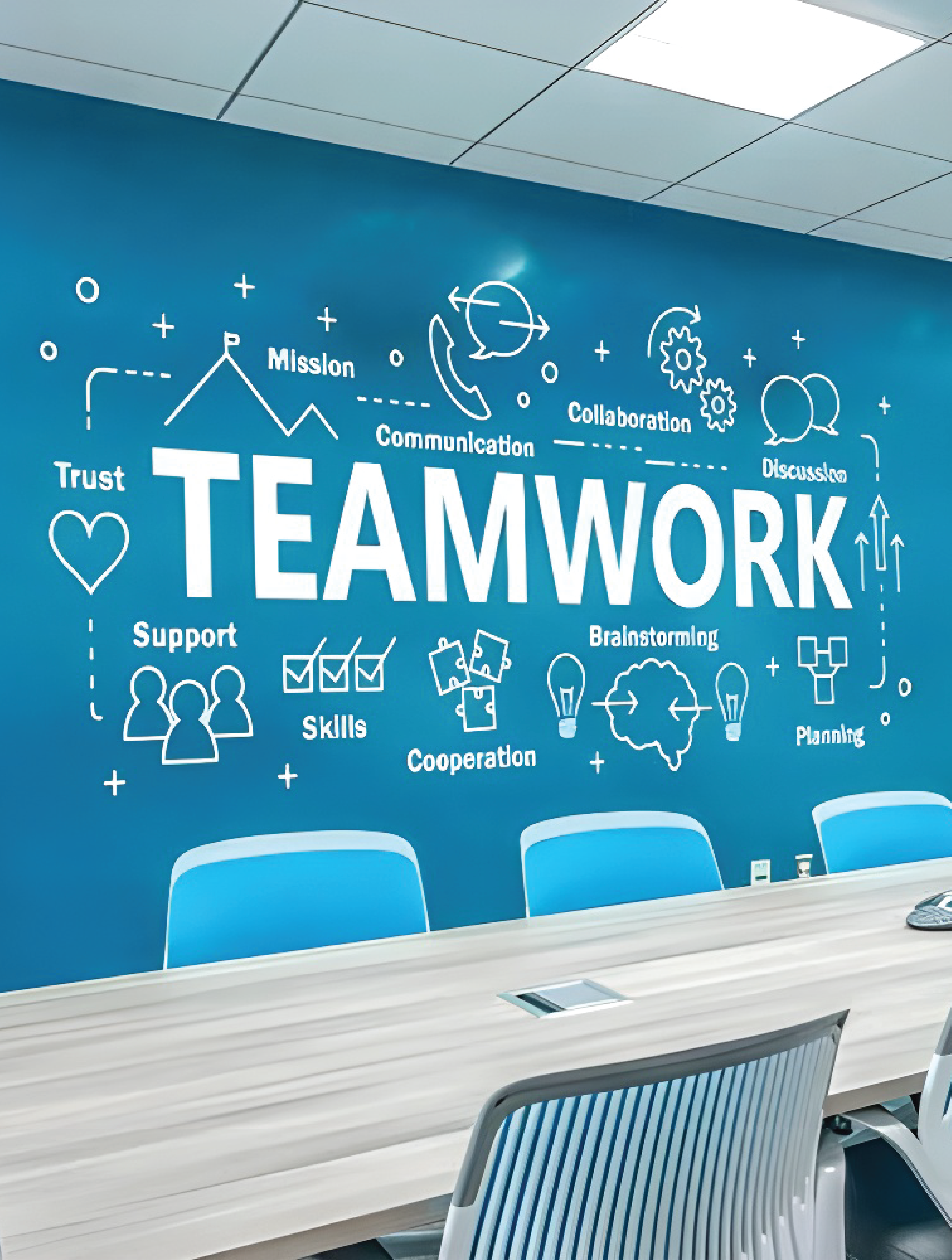 "Professional office wall branding featuring a large 'TEAMWORK' vinyl decal with business icons on a blue office wall."